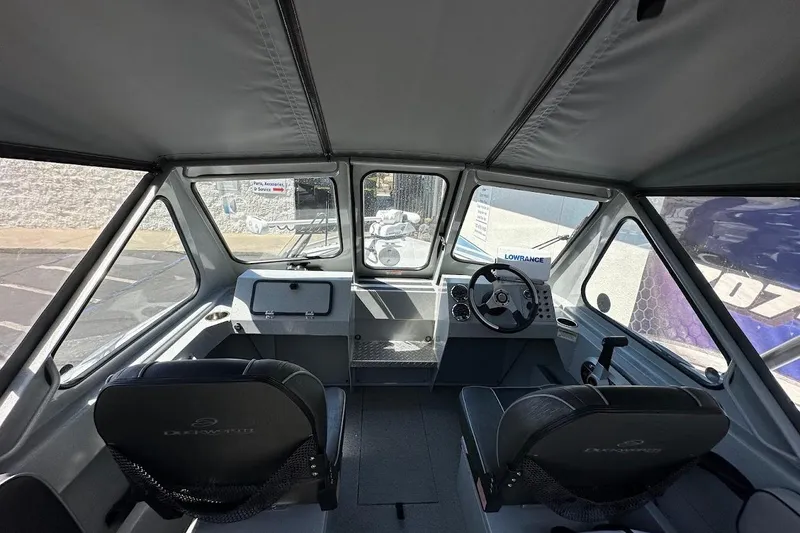 Slide: The Image of Interior of a 2017 Duckworth 18 Advantage boat with steering wheel and seating. - 23