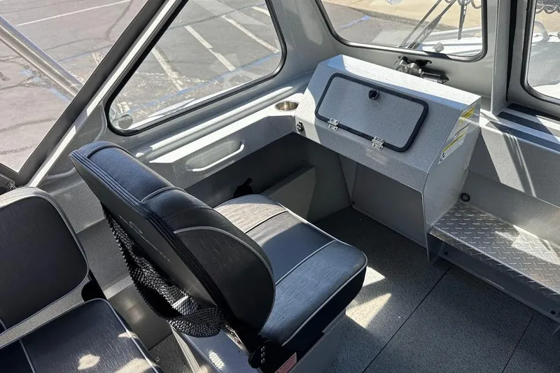 Slide: The Image of Interior of a 2017 Duckworth 18 Advantage boat, featuring seating and storage compartments. - 24