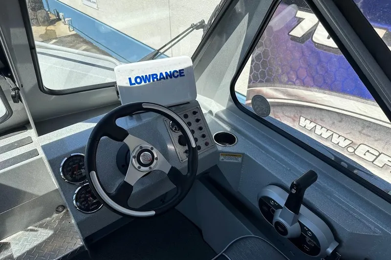 Slide: The Image of 2017 Duckworth 18 Advantage boat cockpit with steering wheel and Lowrance navigation system. - 26