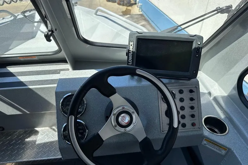 Slide: The Image of 2017 Duckworth 18 Advantage boat dashboard with steering wheel and Lowrance display. - 27
