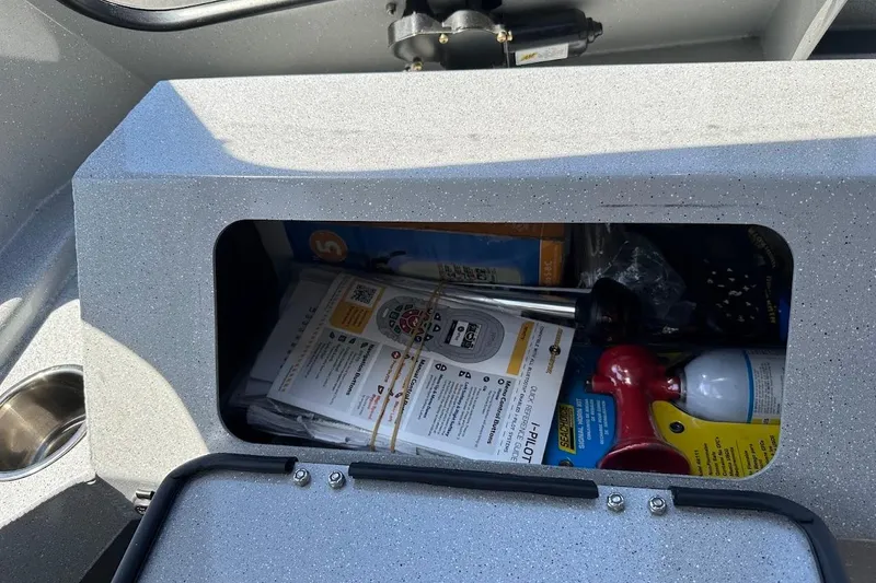 Slide: The Image of Storage compartment in a 2017 Duckworth 18 Advantage boat with manuals and equipment. - 30