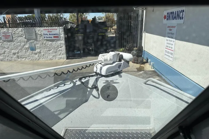 Slide: The Image of 2017 Duckworth 18 Advantage boat with trolling motor, parked near a marine service entrance. - 33