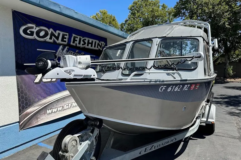 Slide: The Image of 2017 Duckworth 18 Advantage boat on trailer, parked near "Gone Fishin'" sign. - 5