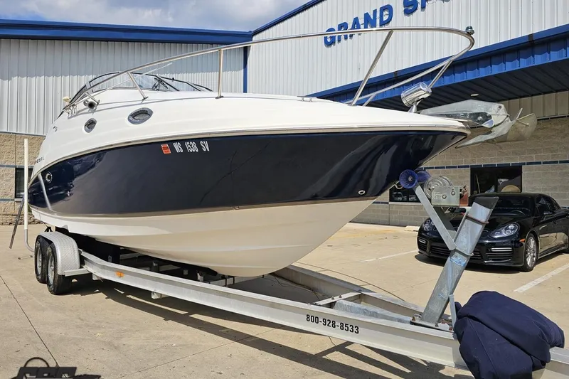 Slide: The Image of 2003 Regal Commodore 2665 boat on trailer outside dealership, showcasing sleek design. - 10