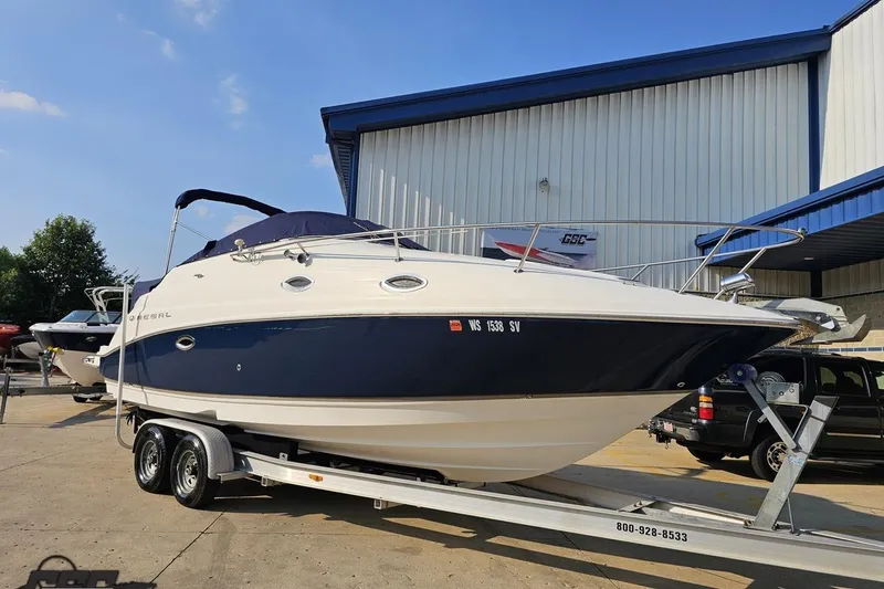 Slide: The Image of 2003 Regal Commodore 2665 boat on trailer outside a warehouse. - 11