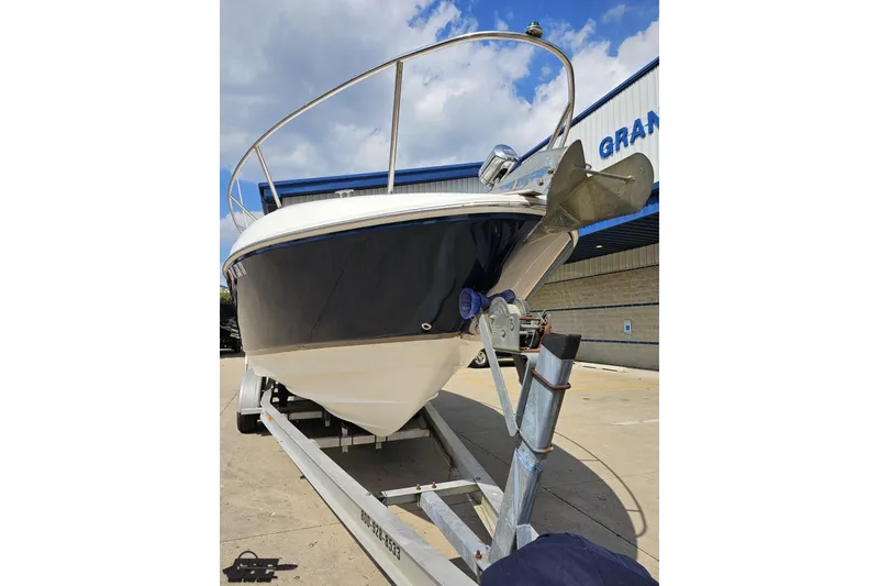 Slide: The Image of 2003 Regal Commodore 2665 boat on trailer, parked outdoors under a cloudy sky. - 12