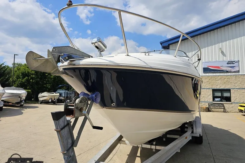 Slide: The Image of 2003 Regal Commodore 2665 boat on trailer, parked outdoors under a partly cloudy sky. - 13
