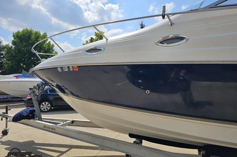 Slide: The Image of 2003 Regal Commodore 2665 boat on trailer under a sunny sky. - 17