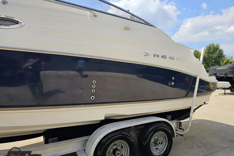 Slide: The Image of 2003 Regal Commodore 2665 boat on trailer, side view with blue and white exterior. - 18