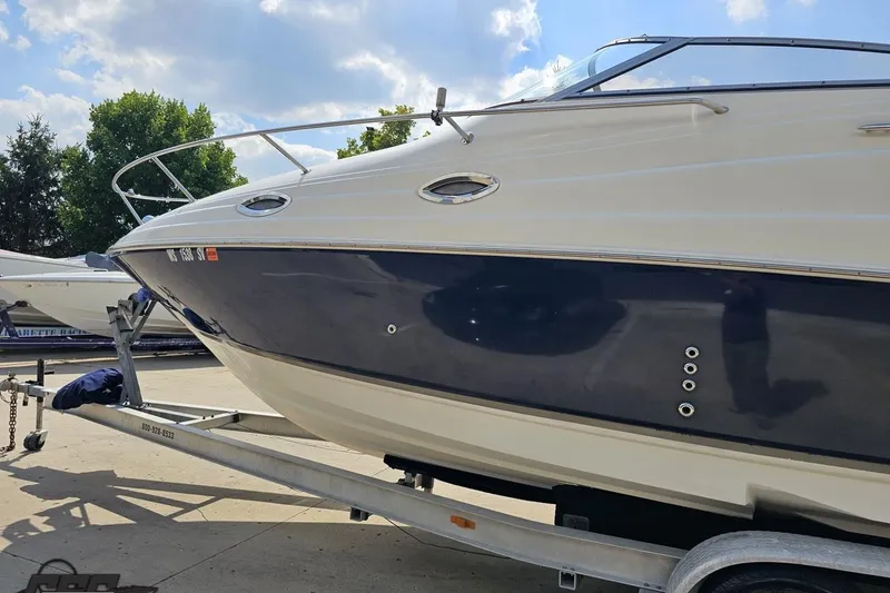 Slide: The Image of 2003 Regal Commodore 2665 boat on trailer under a partly cloudy sky. - 20