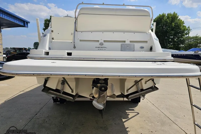 Slide: The Image of Rear view of a 2003 Regal Commodore 2665 boat, showcasing its propellers and swim platform. - 24