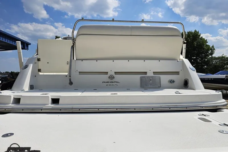 Slide: The Image of 2003 Regal Commodore 2665 boat rear view under a partly cloudy sky. - 25