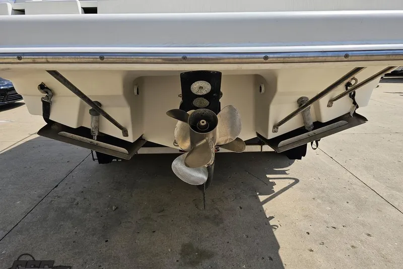 Slide: The Image of Rear view of 2003 Regal Commodore 2665 boat showing propeller and trim tabs. - 26