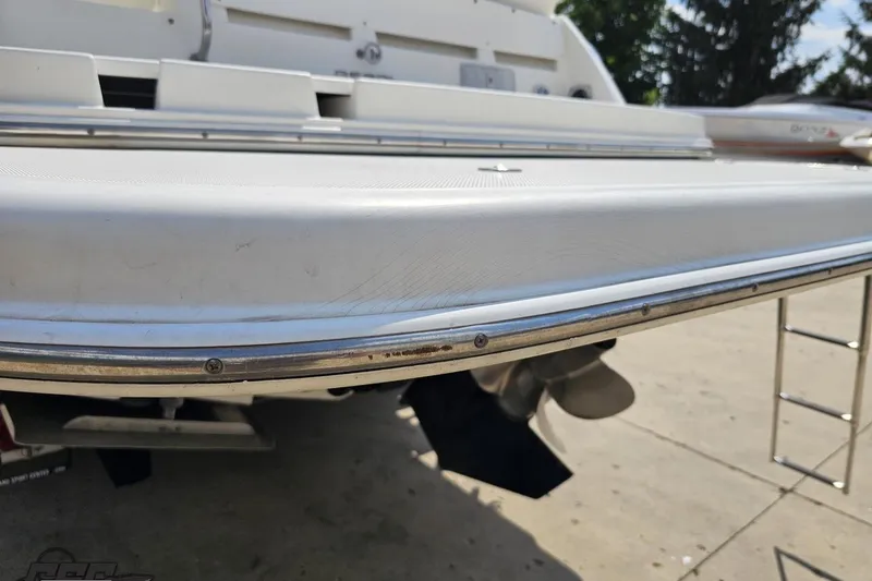 Slide: The Image of Rear view of a 2003 Regal Commodore 2665 boat with visible propeller and swim platform. - 27