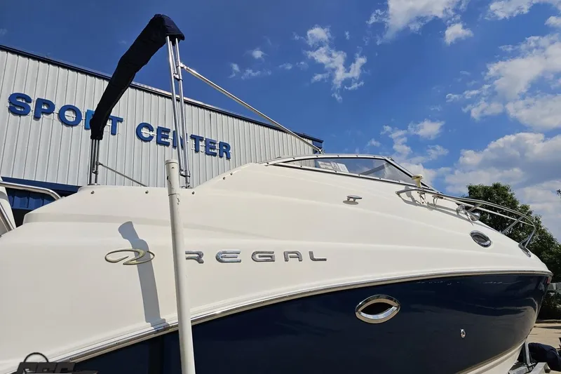 Slide: The Image of 2003 Regal Commodore 2665 boat at a sport center under a blue sky. - 30