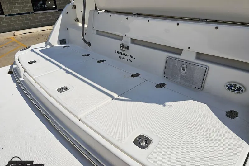 Slide: The Image of 2003 Regal Commodore 2665 boat deck with storage compartments and logo. - 32