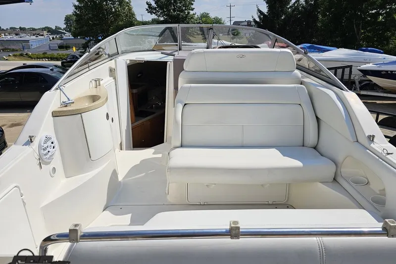 Slide: The Image of 2003 Regal Commodore 2665 boat interior with white seating and compact kitchenette. - 34