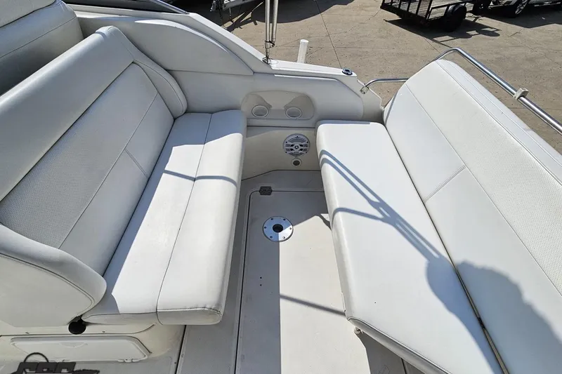 Slide: The Image of 2003 Regal Commodore 2665 boat interior with white cushioned seating. - 37