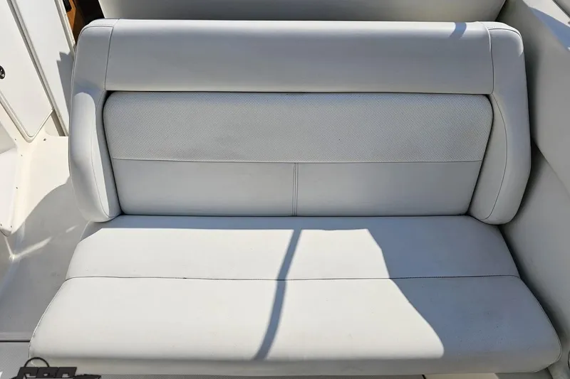Slide: The Image of White leather seat on 2003 Regal Commodore 2665 boat, well-maintained and sunlit. - 41