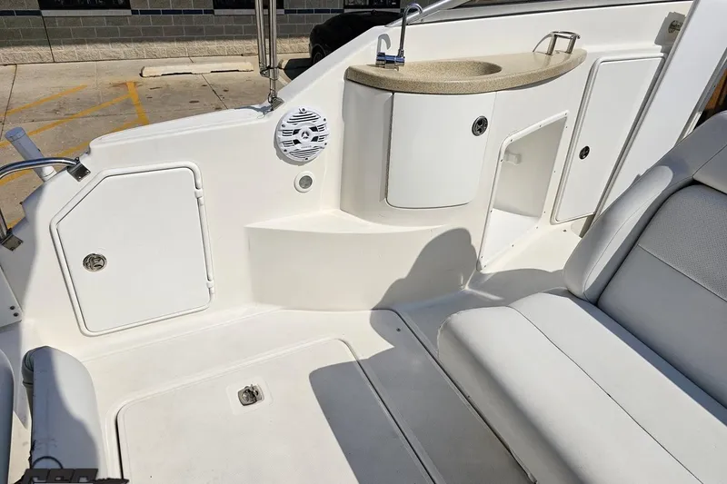 Slide: The Image of 2003 Regal Commodore 2665 boat interior with seating, sink, and storage compartments. - 42
