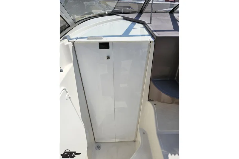 Slide: The Image of 2003 Regal Commodore 2665 boat interior, featuring a sleek white cabin door. - 44