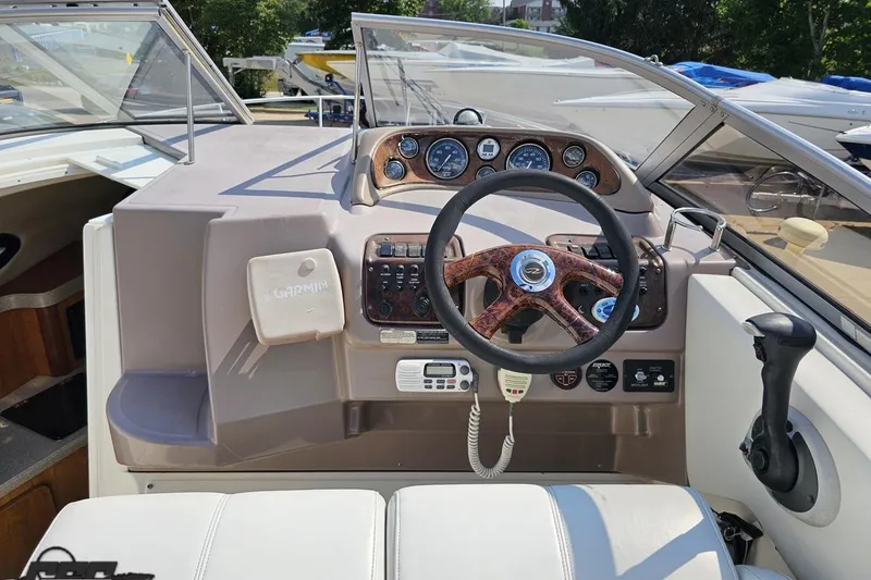 Slide: The Image of 2003 Regal Commodore 2665 boat dashboard with steering wheel and control panel. - 46