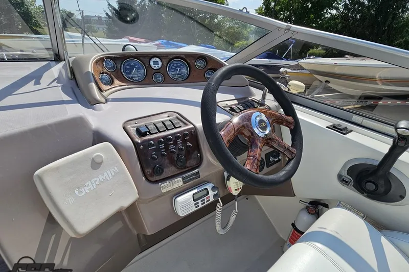 Slide: The Image of Interior of a 2003 Regal Commodore 2665 boat, featuring steering wheel and control panel. - 48
