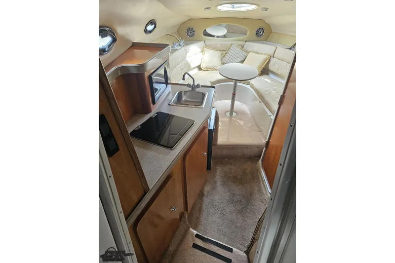 Slide: The Image of Interior of 2003 Regal Commodore 2665 boat with kitchenette and seating area. - 53