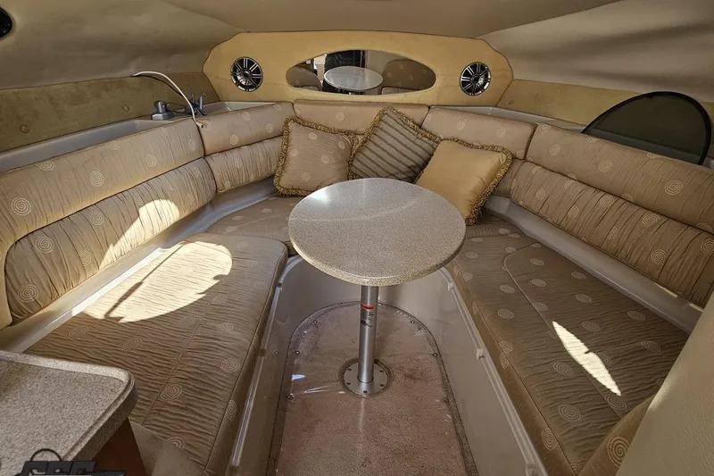 Slide: The Image of Interior of 2003 Regal Commodore 2665 boat with beige seating and round table. - 55