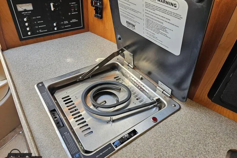 Slide: The Image of 2003 Regal Commodore 2665 boat interior with Kenyon stove and control panel. - 60