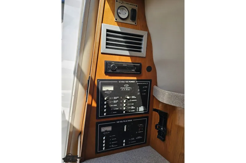 Slide: The Image of Control panel of 2003 Regal Commodore 2665 boat, featuring power and ventilation systems. - 61