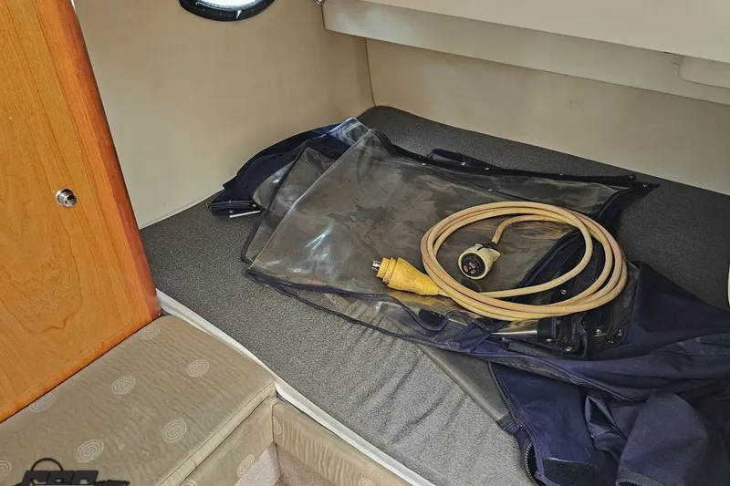 Slide: The Image of 2003 Regal Commodore 2665 cabin interior with coiled power cable and protective cover. - 67