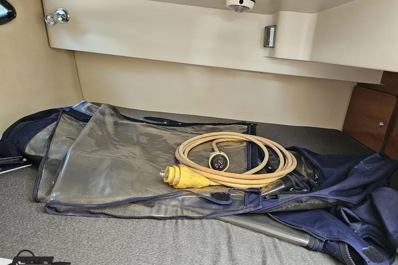 Slide: The Image of 2003 Regal Commodore 2665 cabin with coiled power cable and clear cover. - 68