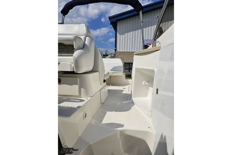 Slide: The Image of 2003 Regal Commodore 2665 boat interior with white seating and storage compartment. - 69