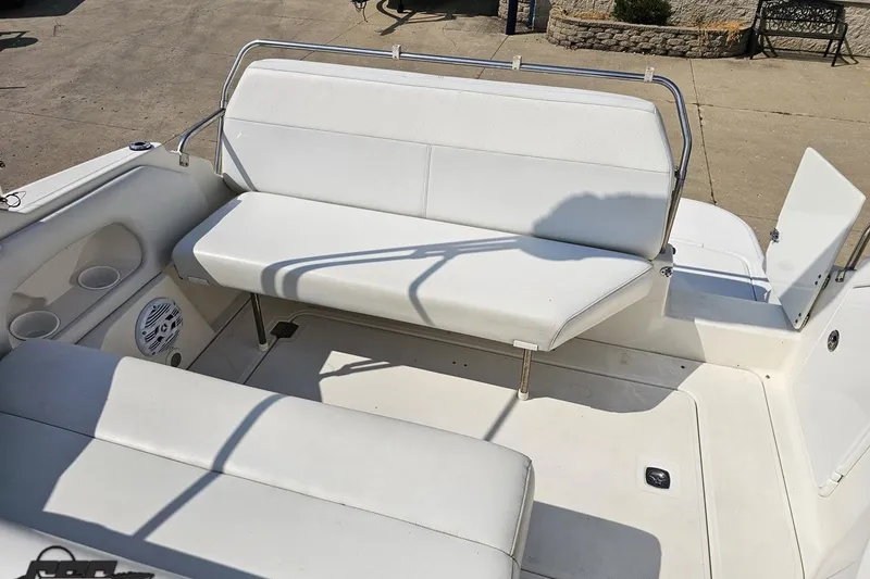 Slide: The Image of 2003 Regal Commodore 2665 boat interior with white seating and cup holders. - 72