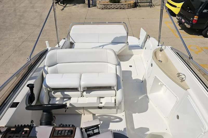 Slide: The Image of 2003 Regal Commodore 2665 boat interior with white seating and steering wheel. - 73