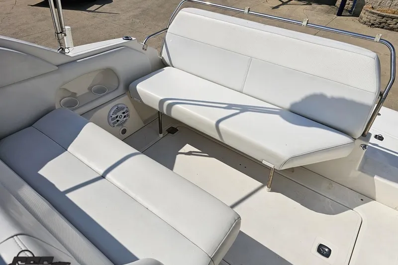 Slide: The Image of 2003 Regal Commodore 2665 boat interior with white seating and cup holders. - 74