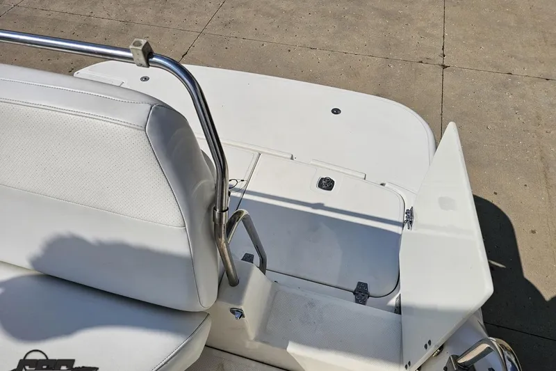 Slide: The Image of 2003 Regal Commodore 2665 boat interior with white seating and storage compartment. - 75