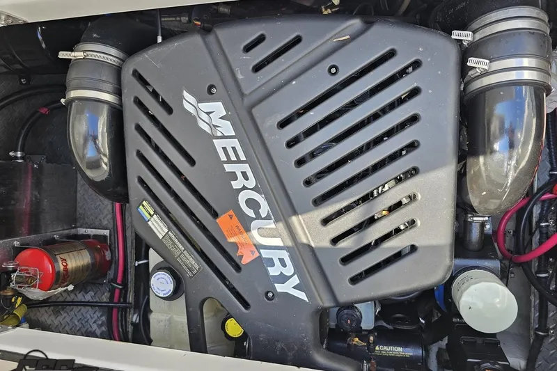 Slide: The Image of Mercury engine in 2003 Regal Commodore 2665 boat, featuring visible components and fire extinguisher. - 76