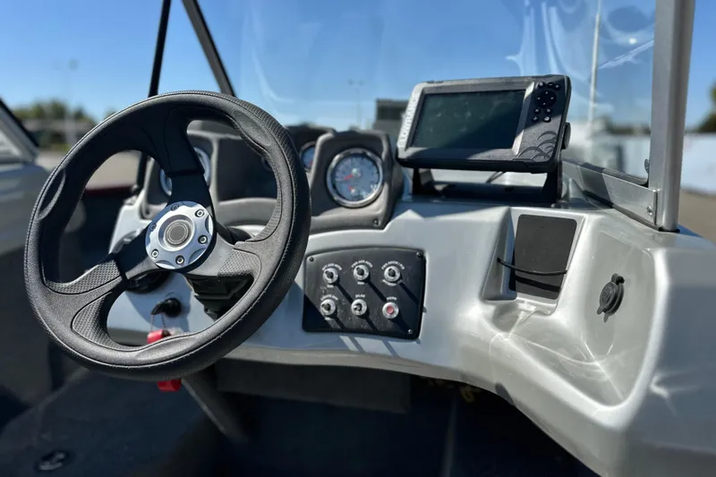 Slide: The Image of 2018 Tracker Pro Guide V-175 WT boat dashboard with steering wheel and controls. - 11