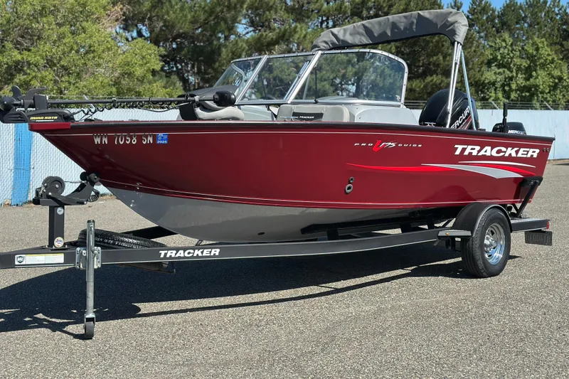 Slide: The Image of 2018 Tracker Pro Guide V-175 WT boat on trailer, red exterior, parked outdoors. - 3