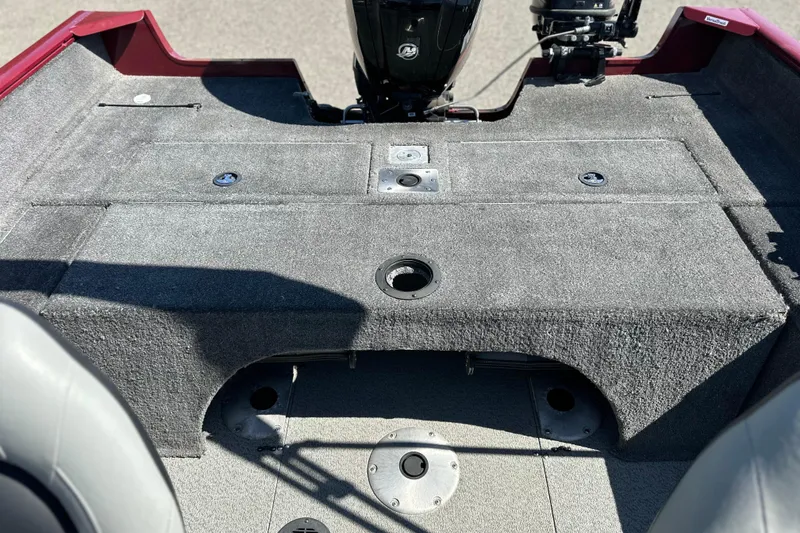 Slide: The Image of 2018 Tracker Pro Guide V-175 WT boat interior with carpeted deck and motor. - 6