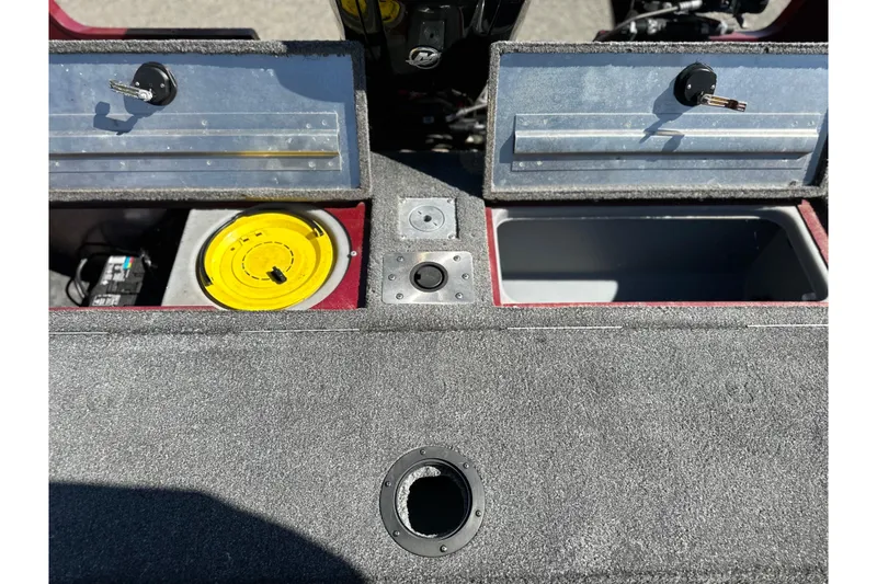 Slide: The Image of 2018 Tracker Pro Guide V-175 WT boat interior with storage compartments and fishing gear. - 8