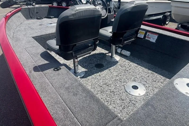 Slide: The Image of 2026 Tracker SG V16 SC boat interior with two seats and carpeted flooring. - 11