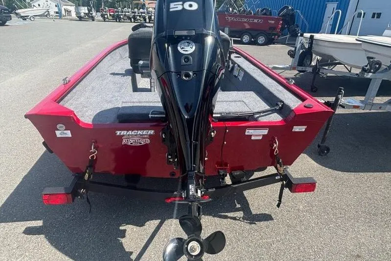 Slide: The Image of Red 2026 Tracker SG V16 SC boat with outboard motor, parked on trailer. - 3