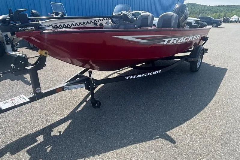 Slide: The Image of Red 2026 Tracker SG V16 SC boat on trailer, parked outdoors. - 8