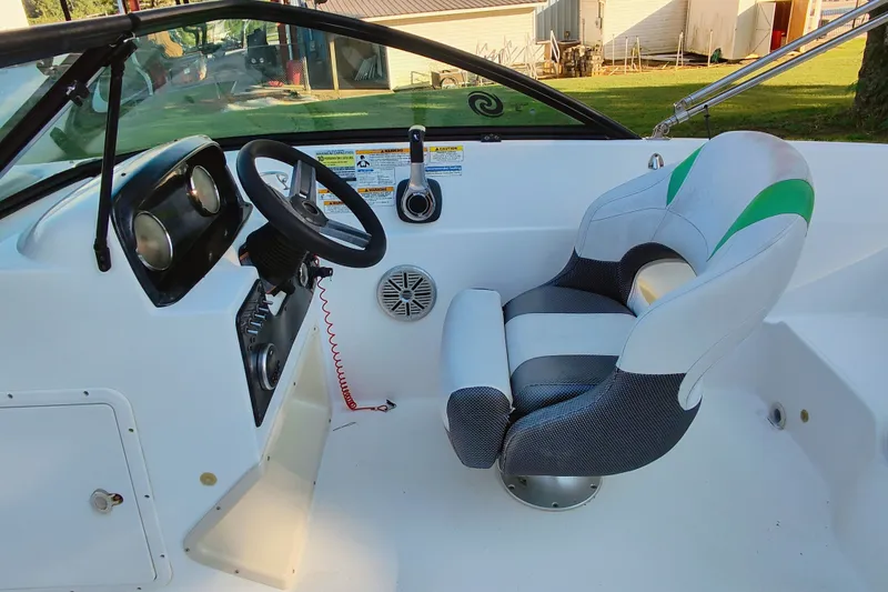 Slide: The Image of Interior of a 2018 Hurricane SD187 boat with steering wheel and captain's chair. - 12