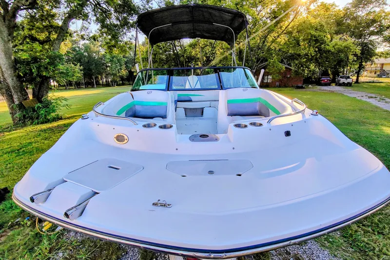 Slide: The Image of 2018 Hurricane SD187 boat on grassy area, surrounded by trees and sunlight. - 4