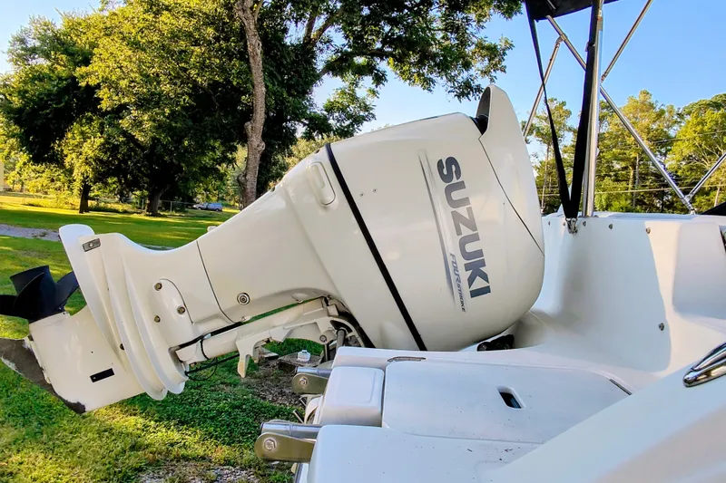 Slide: The Image of Outboard motor on 2018 Hurricane SD187 boat, Suzuki branding, sunny outdoor setting. - 8