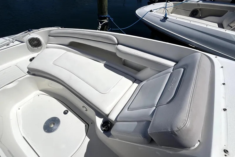 Slide: The Image of 2012 Sea Ray 260 Sundeck boat docked with cover, in a marina setting. - 11